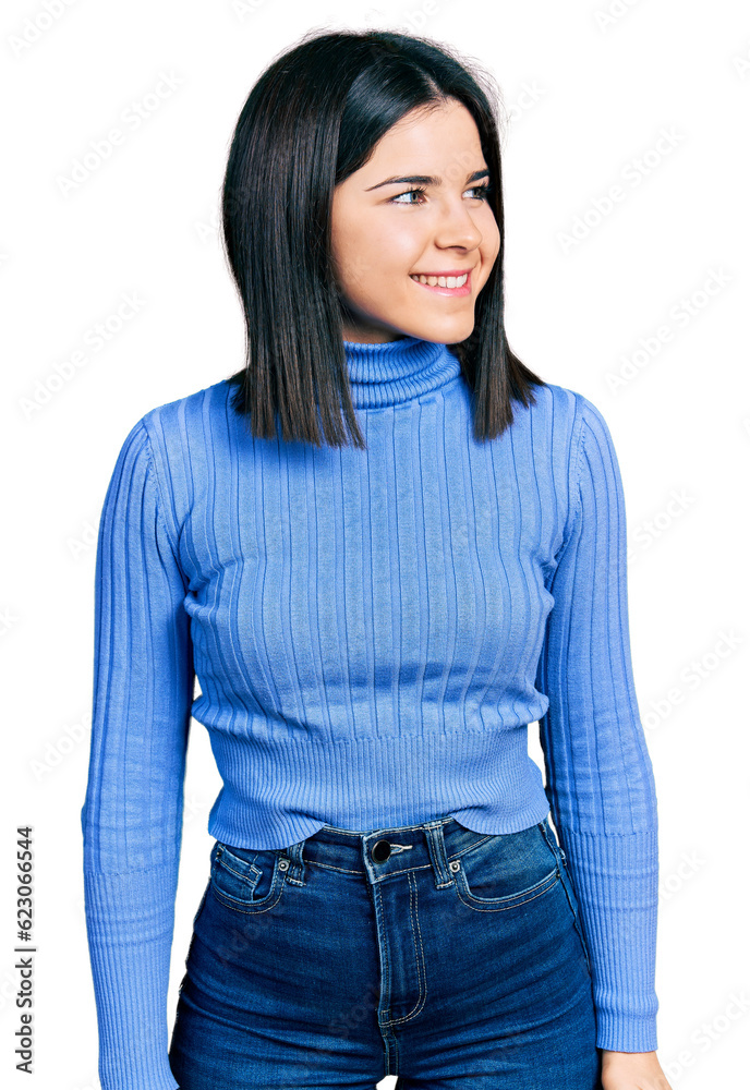 Young brunette woman with blue eyes wearing casual turtleneck sweater looking to side, relax profile pose with natural face and confident smile.