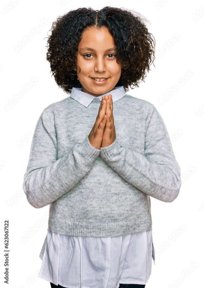 Young little girl with afro hair wearing casual clothes praying with ...
