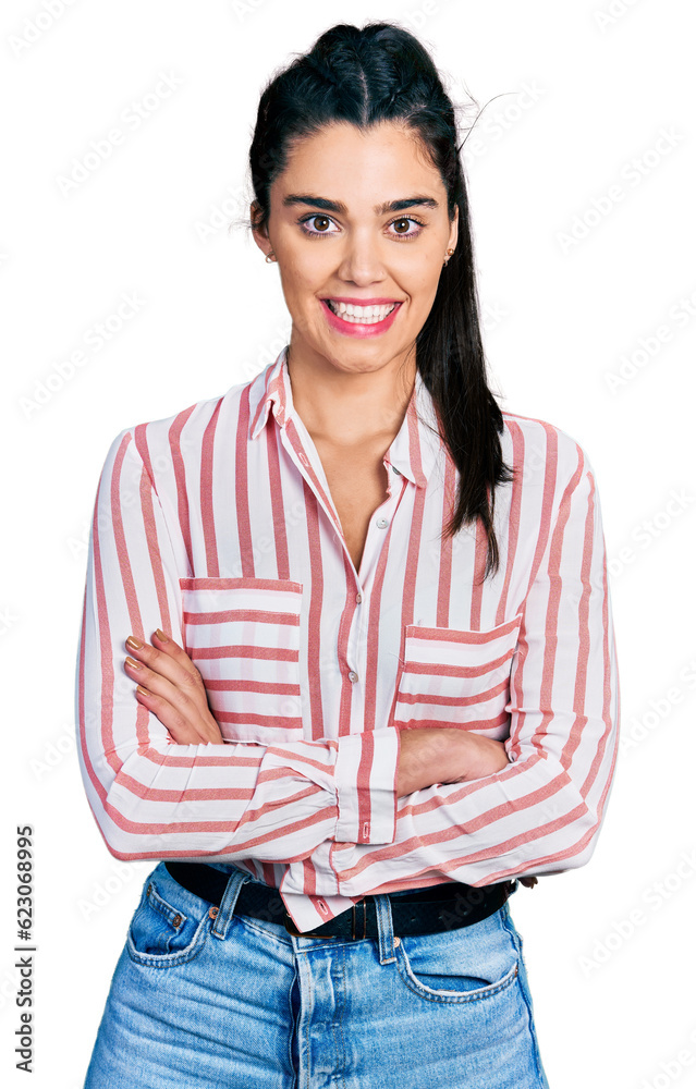 Young hispanic woman wearing casual clothes happy face smiling with crossed arms looking at the camera. positive person. Young hispanic woman wearing casual clothes happy face smiling with crossed arms looking at the camera. positive person.