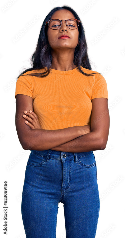 Young indian girl wearing casual clothes and glasses relaxed with serious expression on face. simple and natural looking at the camera. Young indian girl wearing casual clothes and glasses relaxed with serious expression on face. simple and natural looking at the camera.