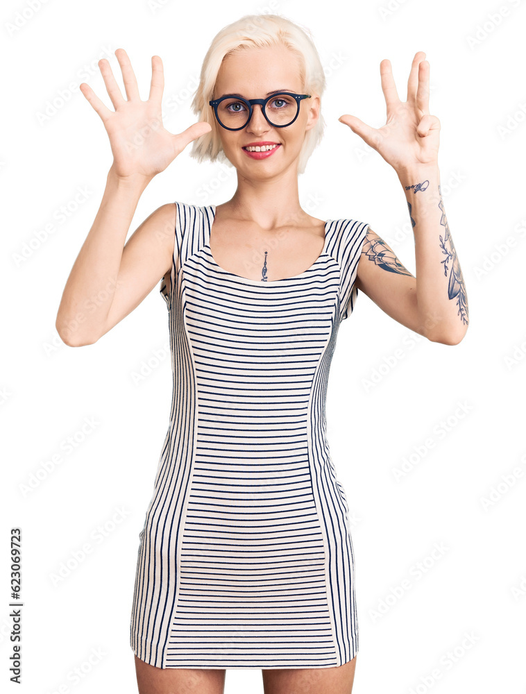 Young blonde woman with tattoo wearing casual clothes and glasses showing and pointing up with fingers number nine while smiling confident and happy. Young blonde woman with tattoo wearing casual clothes and glasses showing and pointing up with fingers number nine while smiling confident and happy.