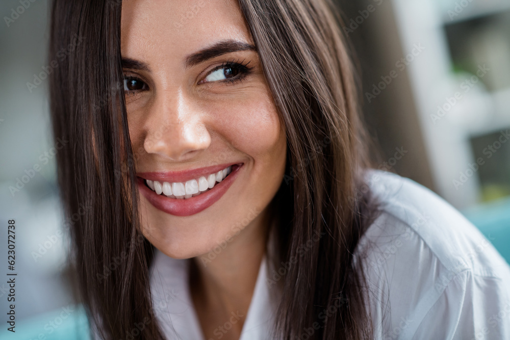 Close up portrait of sweet nice person smiling toothy with shiny veneers in comfy house living room flat Close up portrait of sweet nice person smiling toothy with shiny veneers in comfy house living room flat