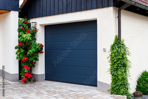automatic garage doors near manicured blooming roses photo