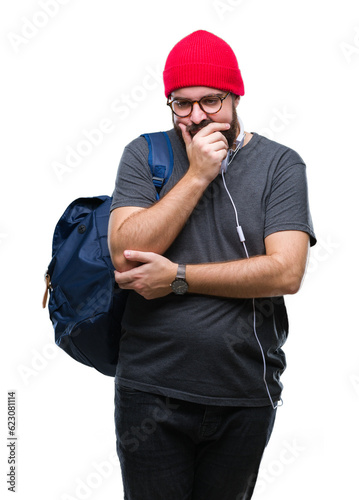 Young hipster man wearing red wool cap and backpack over isolated background thinking looking tired and bored with depression problems with crossed arms.