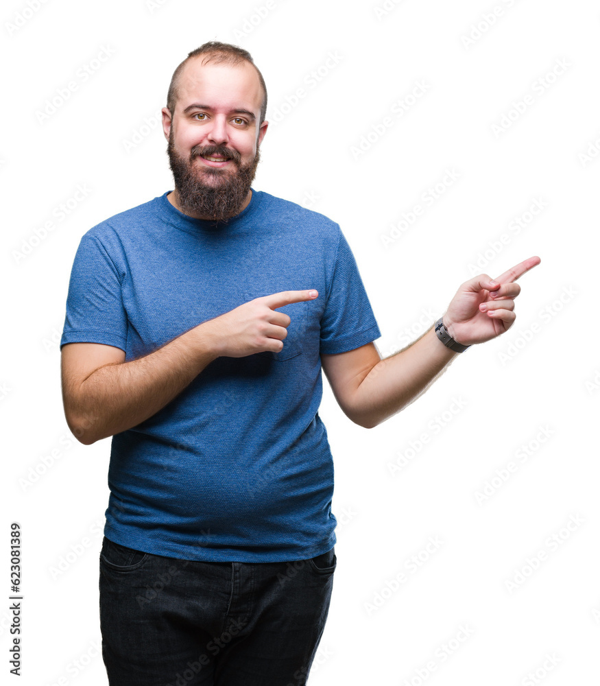 Young caucasian hipster man over isolated background with a big smile on face, pointing with hand and finger to the side looking at the camera. Young caucasian hipster man over isolated background with a big smile on face, pointing with hand and finger to the side looking at the camera.