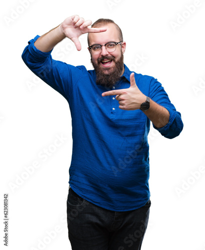 Young caucasian hipster man wearing glasses over isolated background smiling making frame with hands and fingers with happy face. Creativity and photography concept.