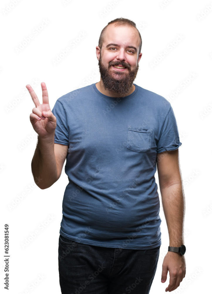 Fototapeta premium Young caucasian hipster man over isolated background smiling with happy face winking at the camera doing victory sign. Number two.