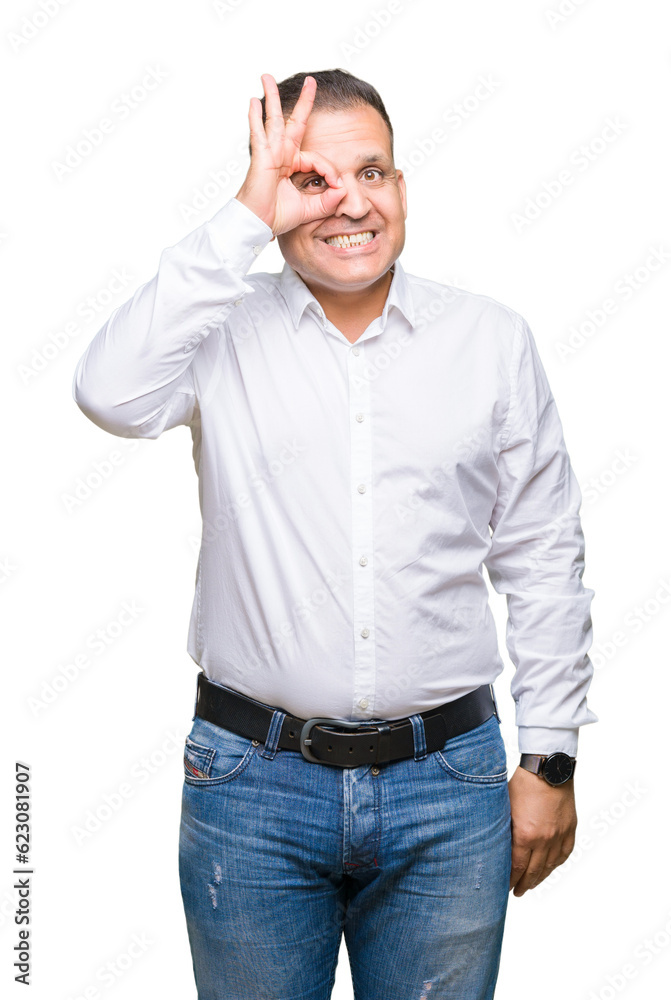 Middle age arab elegant man over isolated background doing ok gesture with hand smiling, eye looking through fingers with happy face. Middle age arab elegant man over isolated background doing ok gesture with hand smiling, eye looking through fingers with happy face.