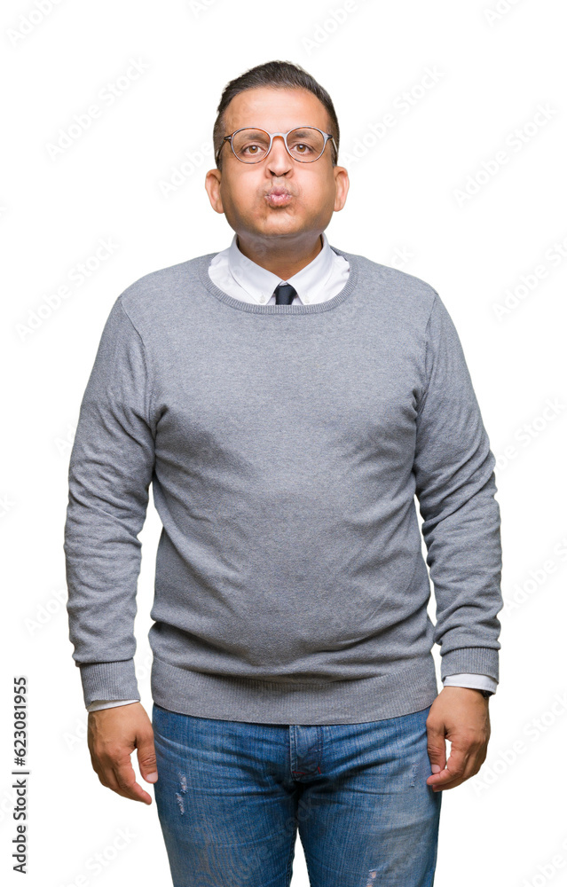 Middle age bussines arab man wearing glasses over isolated background puffing cheeks with funny face. Mouth inflated with air, crazy expression. Middle age bussines arab man wearing glasses over isolated background puffing cheeks with funny face. Mouth inflated with air, crazy expression.