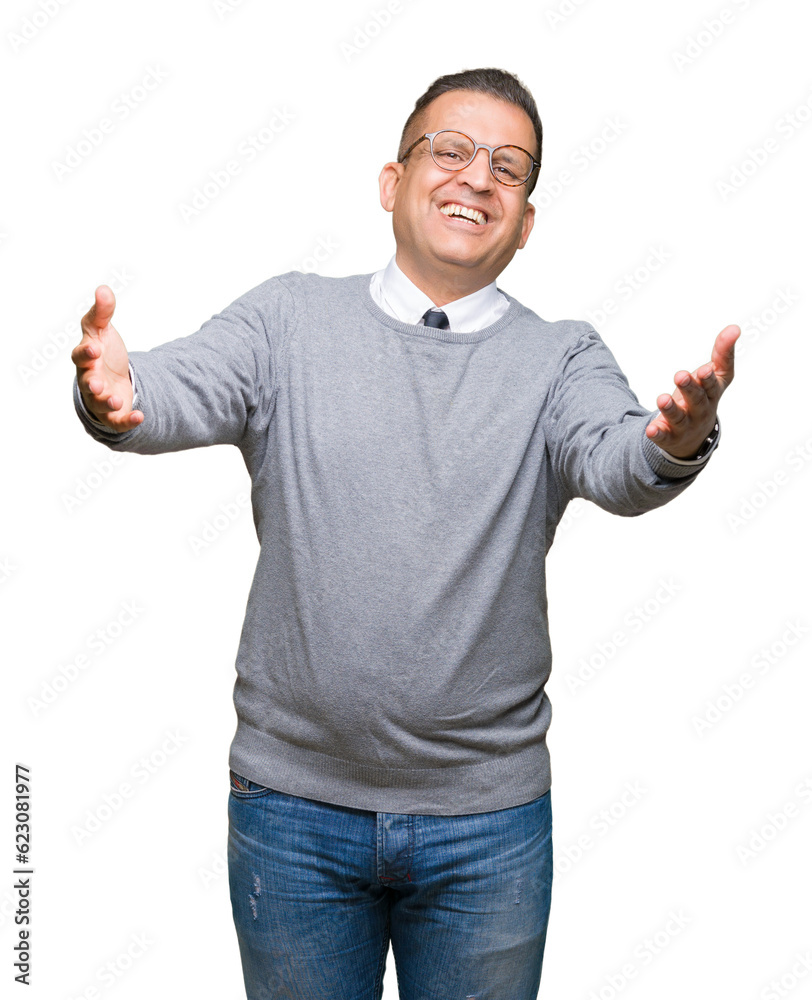 Middle age bussines arab man wearing glasses over isolated background looking at the camera smiling with open arms for hug. Cheerful expression embracing happiness.