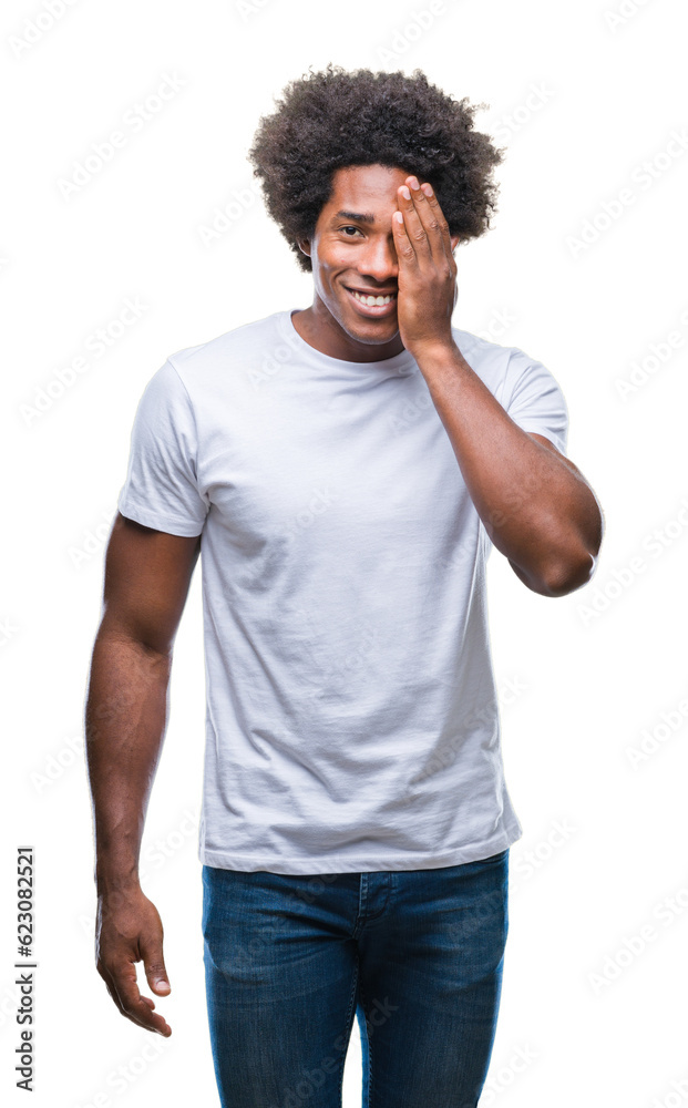 Afro american man over isolated background covering one eye with hand with confident smile on face and surprise emotion. Afro american man over isolated background covering one eye with hand with confident smile on face and surprise emotion.