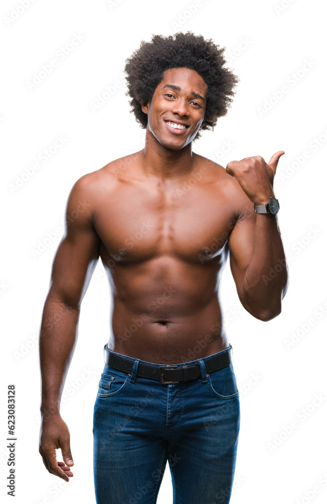 Afro american shirtless man showing nude body over isolated background smiling with happy face looking and pointing to the side with thumb up. Afro american shirtless man showing nude body over isolated background smiling with happy face looking and pointing to the side with thumb up.
