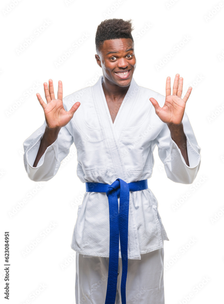 Young african american man over isolated background wearing kimono showing and pointing up with fingers number ten while smiling confident and happy. Young african american man over isolated background wearing kimono showing and pointing up with fingers number ten while smiling confident and happy.