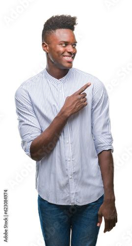 Young african american man over isolated background cheerful with a smile of face pointing with hand and finger up to the side with happy and natural expression on face looking at the camera.