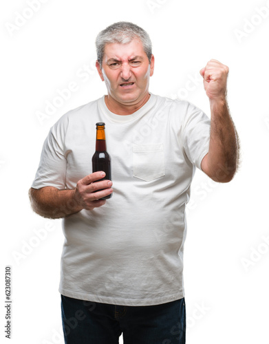 Handsome senior man drinking beer bottle over isolated background annoyed and frustrated shouting with anger, crazy and yelling with raised hand, anger concept