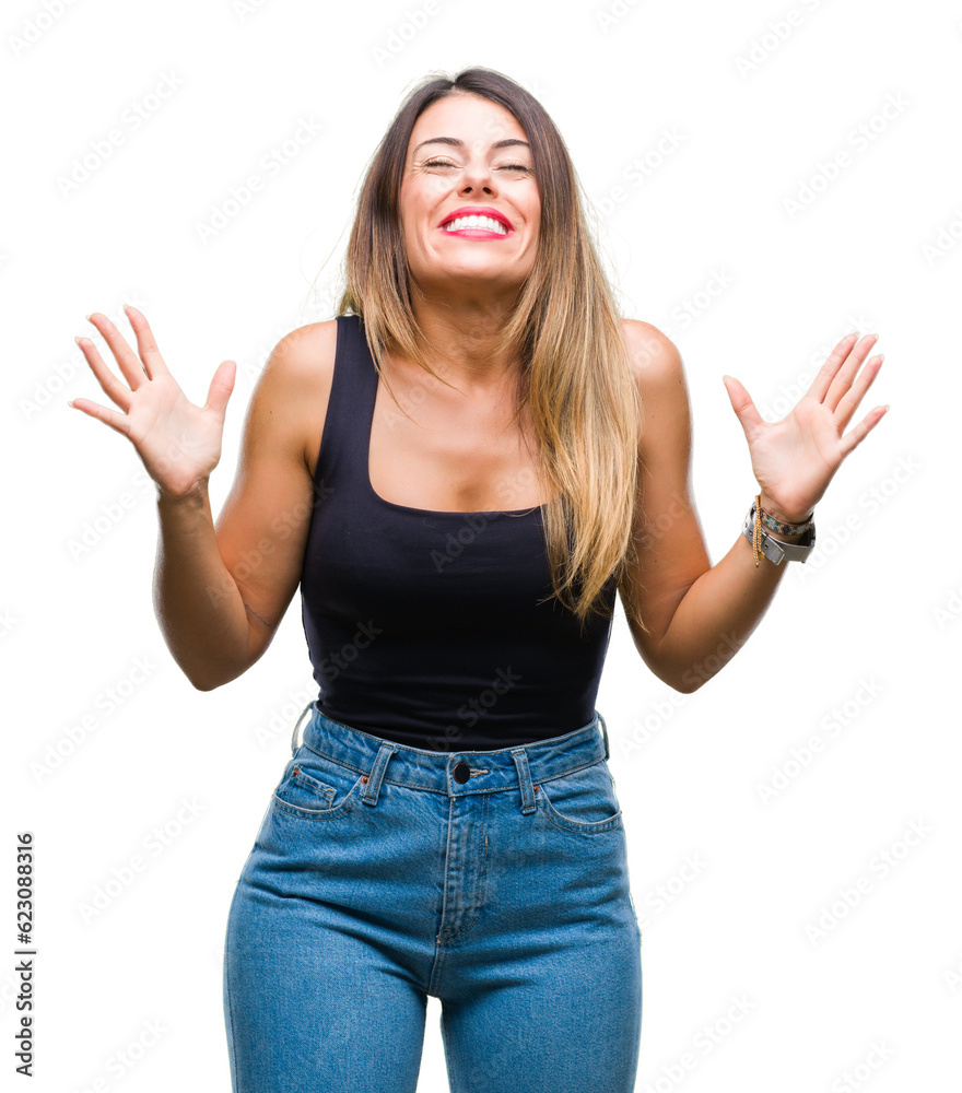 Young beautiful woman over isolated background celebrating mad and crazy for success with arms raised and closed eyes screaming excited. Winner concept Young beautiful woman over isolated background celebrating mad and crazy for success with arms raised and closed eyes screaming excited. Winner concept