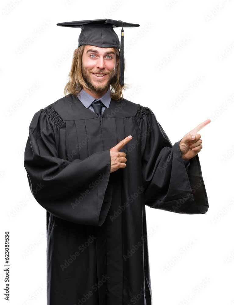 Young handsome graduated man with long hair over isolated background smiling and looking at the camera pointing with two hands and fingers to the side. Young handsome graduated man with long hair over isolated background smiling and looking at the camera pointing with two hands and fingers to the side.