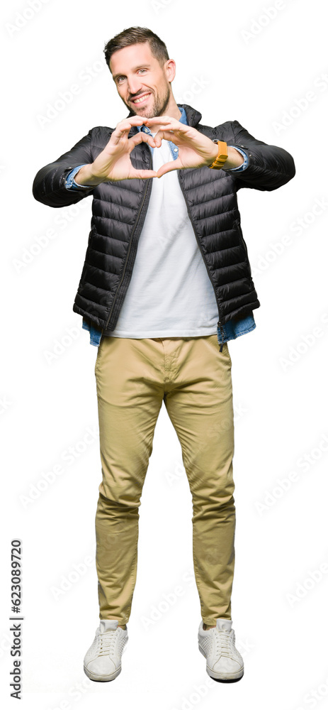 Handsome man wearing winter coat smiling in love showing heart symbol and shape with hands. Romantic concept. Handsome man wearing winter coat smiling in love showing heart symbol and shape with hands. Romantic concept.