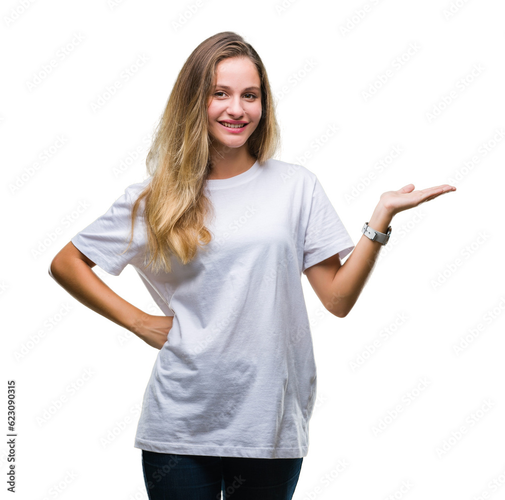 Young beautiful blonde woman wearing casual white t-shirt over isolated background smiling cheerful presenting and pointing with palm of hand looking at the camera.