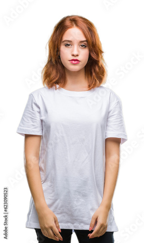 Young beautiful woman over isolated background with serious expression on face. Simple and natural looking at the camera.