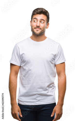 Young handsome man over isolated background smiling looking side and staring away thinking.