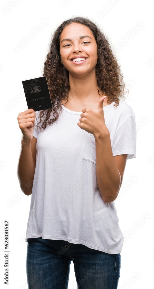 Young hispanic woman holding passport of Australia happy with big smile doing ok sign, thumb up with fingers, excellent sign Young hispanic woman holding passport of Australia happy with big smile doing ok sign, thumb up with fingers, excellent sign