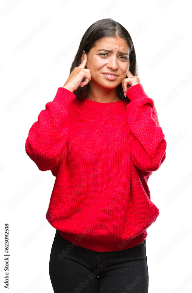 Young beautiful arab woman wearing winter sweater over isolated background covering ears with fingers with annoyed expression for the noise of loud music. Deaf concept. Young beautiful arab woman wearing winter sweater over isolated background covering ears with fingers with annoyed expression for the noise of loud music. Deaf concept.