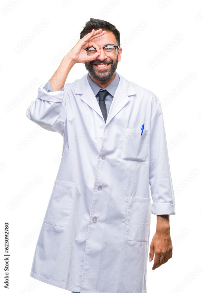 Adult hispanic scientist or doctor man wearing white coat over isolated background doing ok gesture with hand smiling, eye looking through fingers with happy face. Adult hispanic scientist or doctor man wearing white coat over isolated background doing ok gesture with hand smiling, eye looking through fingers with happy face.