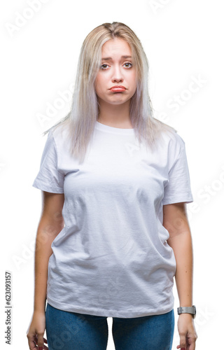 Young blonde woman over isolated background depressed and worry for distress, crying angry and afraid. Sad expression.