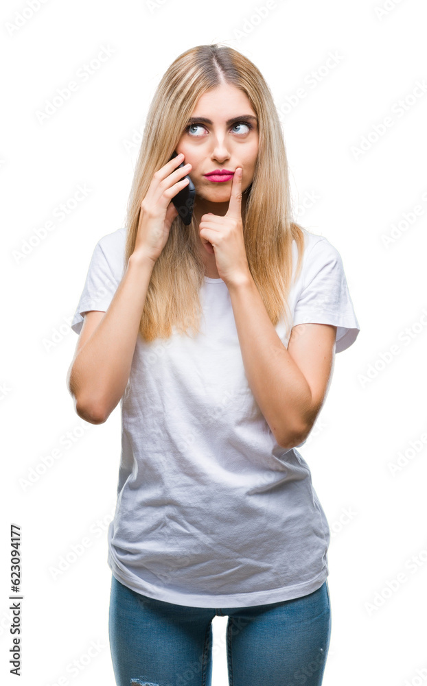 Young beautiful blonde woman talking using smartphone over isolated background serious face thinking about question, very confused idea Young beautiful blonde woman talking using smartphone over isolated background serious face thinking about question, very confused idea