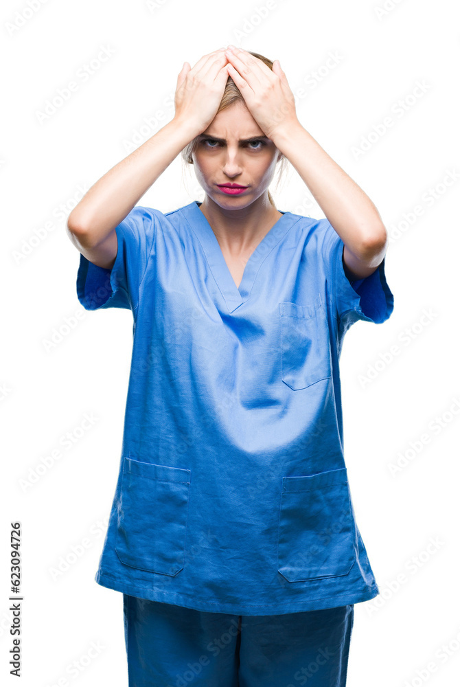 Young beautiful blonde doctor surgeon nurse woman over isolated background suffering from headache desperate and stressed because pain and migraine. Hands on head. Young beautiful blonde doctor surgeon nurse woman over isolated background suffering from headache desperate and stressed because pain and migraine. Hands on head.