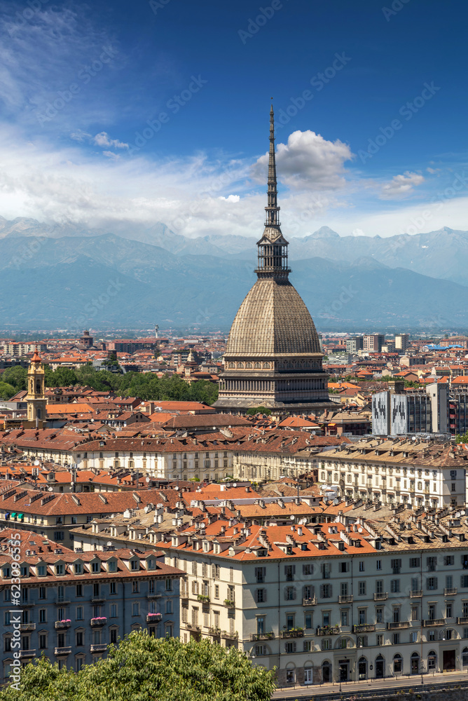 Turin, Piedmont, Italy - cityscape seen from above with the Mole Antonelliana architecture symbol of the city of Turin, in the background the Alps with blue sky with clouds