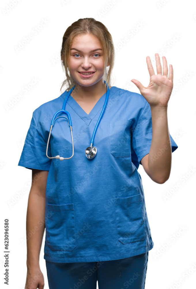 Young caucasian doctor woman wearing surgeon uniform over isolated background showing and pointing up with fingers number five while smiling confident and happy. Young caucasian doctor woman wearing surgeon uniform over isolated background showing and pointing up with fingers number five while smiling confident and happy.