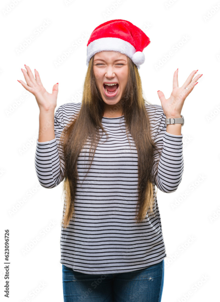 Young beautiful caucasian woman wearing christmas hat over isolated background celebrating crazy and amazed for success with arms raised and open eyes screaming excited. Winner concept Young beautiful caucasian woman wearing christmas hat over isolated background celebrating crazy and amazed for success with arms raised and open eyes screaming excited. Winner concept