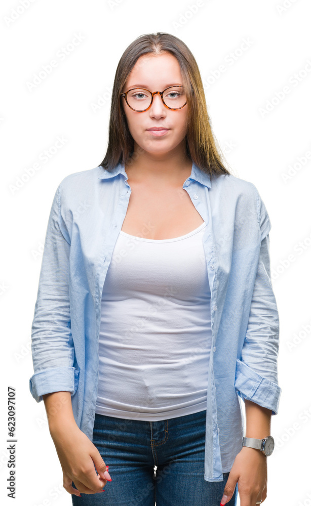 Obraz premium Young caucasian beautiful business woman wearing glasses over isolated background with serious expression on face. Simple and natural looking at the camera.