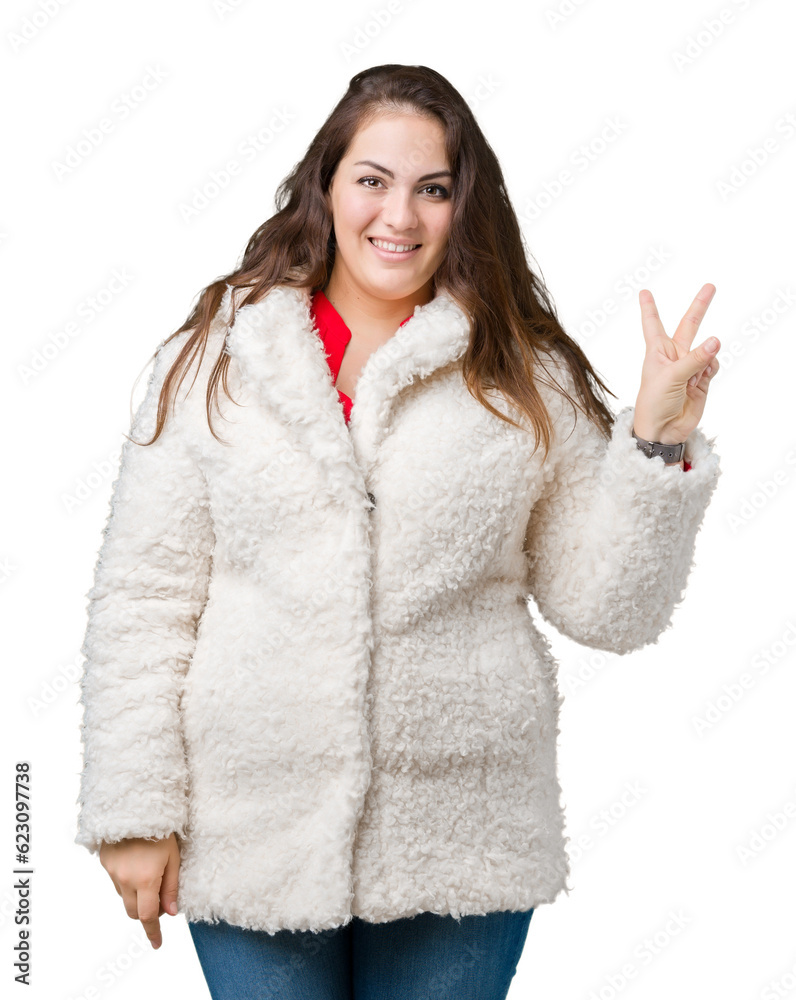 Beautiful plus size young woman wearing winter sheep coat over isolated background smiling with happy face winking at the camera doing victory sign. Number two. Beautiful plus size young woman wearing winter sheep coat over isolated background smiling with happy face winking at the camera doing victory sign. Number two.