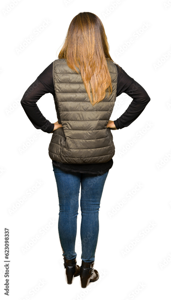 Obraz premium Beautiful middle age woman wearing winter vest standing backwards looking away with arms on body