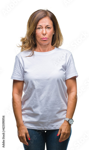 Middle age senior hispanic woman over isolated background depressed and worry for distress, crying angry and afraid. Sad expression.
