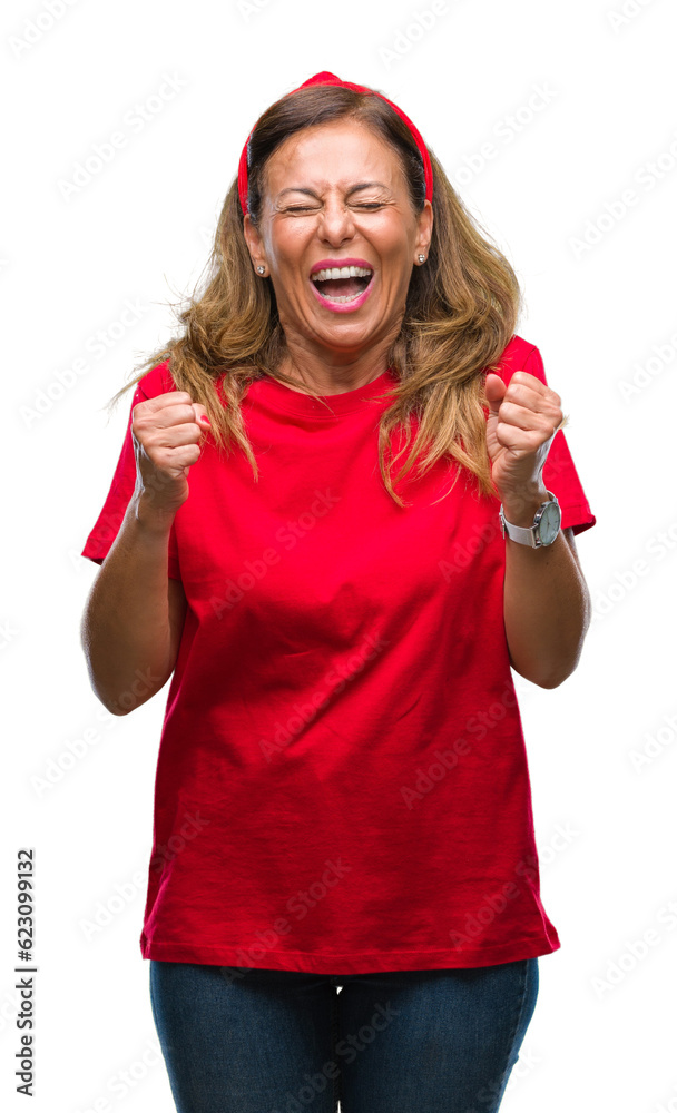 Middle age senior hispanic woman over isolated background excited for success with arms raised celebrating victory smiling. Winner concept.