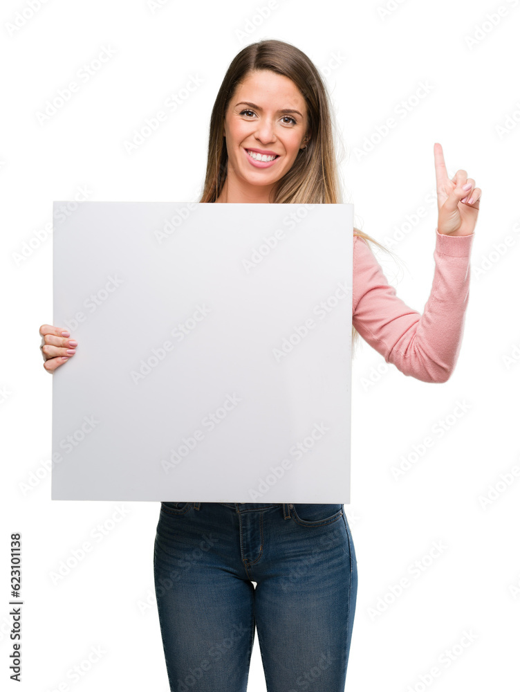 Beautiful young woman holding advertising banner surprised with an idea or question pointing finger with happy face, number one Beautiful young woman holding advertising banner surprised with an idea or question pointing finger with happy face, number one