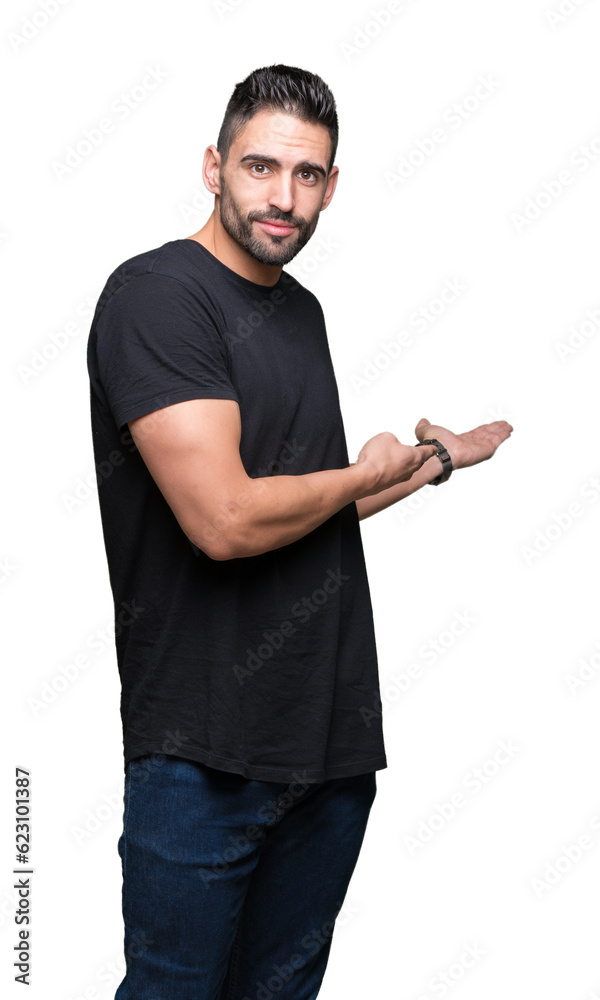 Young handsome man over isolated background Inviting to enter smiling natural with open hand Young handsome man over isolated background Inviting to enter smiling natural with open hand
