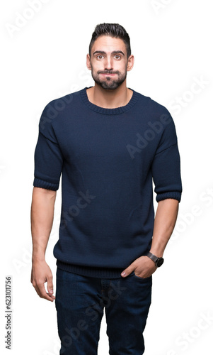 Young handsome man wearing sweater over isolated background puffing cheeks with funny face. Mouth inflated with air, crazy expression.