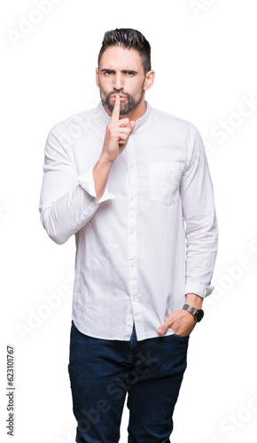 Young business man over isolated background asking to be quiet with finger on lips. Silence and secret concept. © Krakenimages.com
