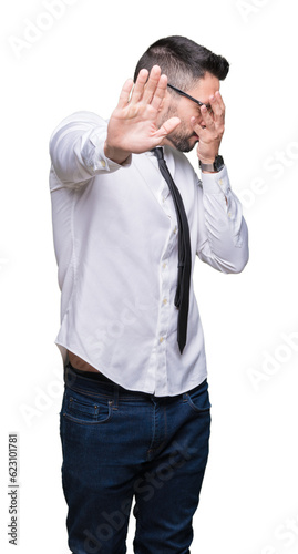 Young handsome business man wearing glasses over isolated background covering eyes with hands and doing stop gesture with sad and fear expression. Embarrassed and negative concept.