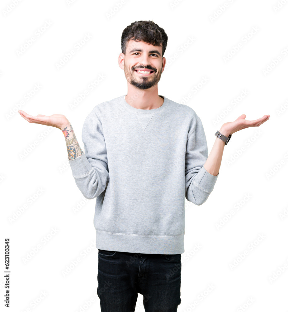 Young handsome man wearing sweatshirt over isolated background Smiling showing both hands open palms, presenting and advertising comparison and balance Young handsome man wearing sweatshirt over isolated background Smiling showing both hands open palms, presenting and advertising comparison and balance