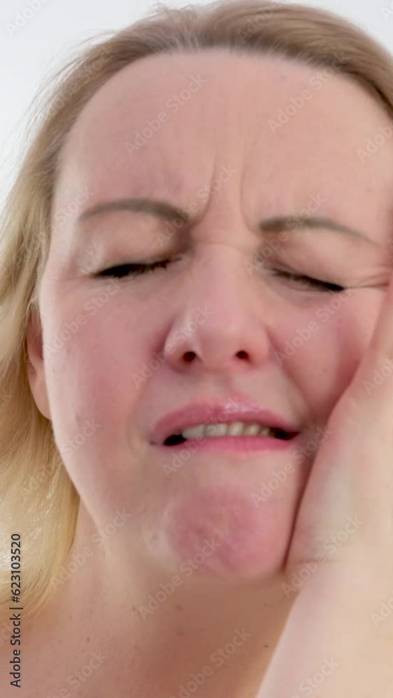 vertical video. Young caucasian woman touch her cheek having severe toothache sitting on couch at home, unhealthy brunette girl 20s suffers from painful sensations need dental service, medical vertical video. Young caucasian woman touch her cheek having severe toothache sitting on couch at home, unhealthy brunette girl 20s suffers from painful sensations need dental service, medical