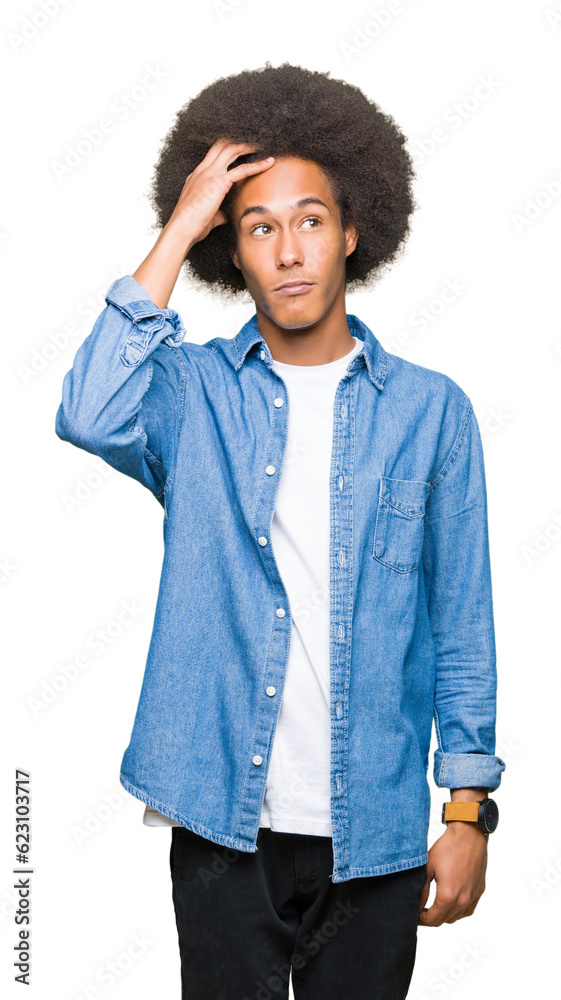 Young african american man with afro hair confuse and wonder about question. Uncertain with doubt, thinking with hand on head. Pensive concept. Young african american man with afro hair confuse and wonder about question. Uncertain with doubt, thinking with hand on head. Pensive concept.