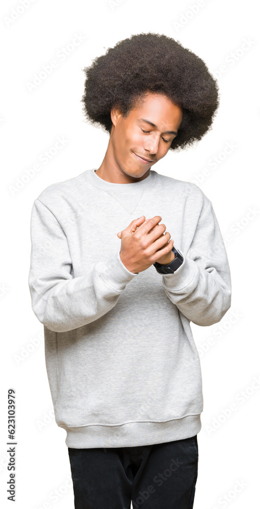 Young african american man with afro hair wearing sporty sweatshirt Suffering pain on hands and fingers, arthritis inflammation Young african american man with afro hair wearing sporty sweatshirt Suffering pain on hands and fingers, arthritis inflammation