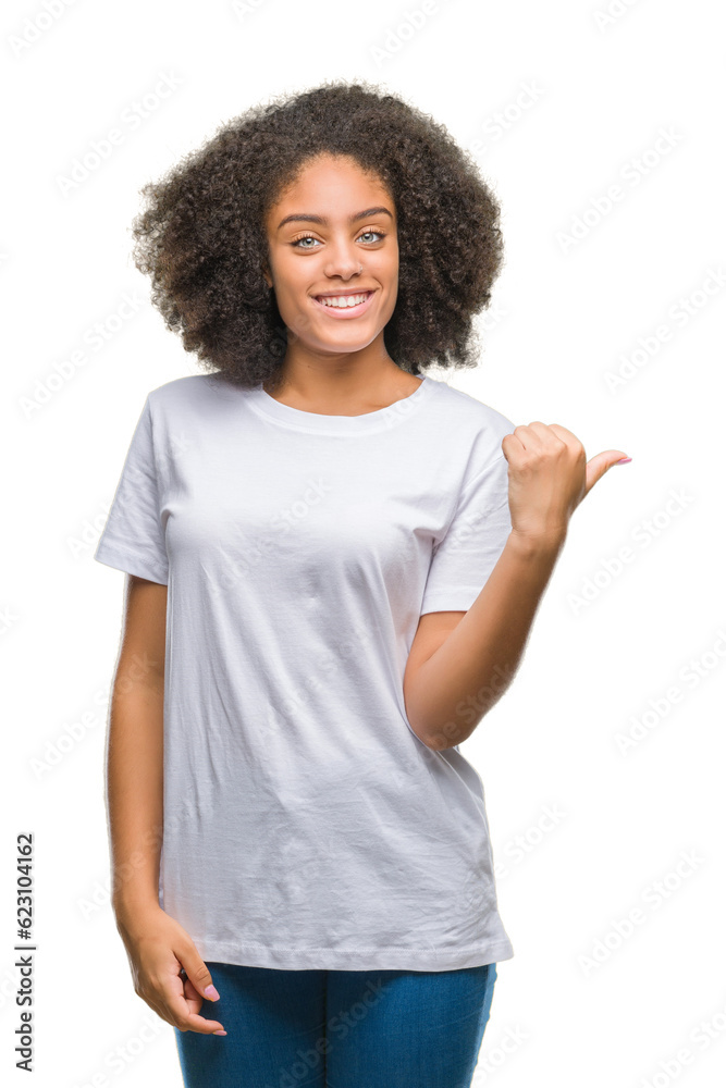 Young afro american woman over isolated background smiling with happy face looking and pointing to the side with thumb up. Young afro american woman over isolated background smiling with happy face looking and pointing to the side with thumb up.
