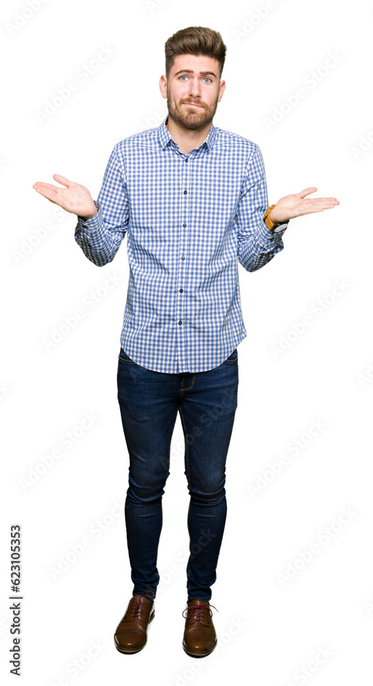 Young handsome bussines man clueless and confused expression with arms and hands raised. Doubt concept. Young handsome bussines man clueless and confused expression with arms and hands raised. Doubt concept.